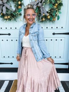 Brooke Riley standing in front off double doors with wreaths.