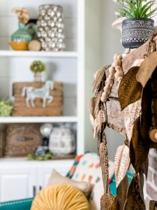 metal leaf garland on fall mantel with fall styled shelving in background