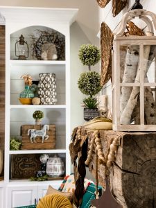 metal leaf garland on fall mantel with fall styled shelving in background